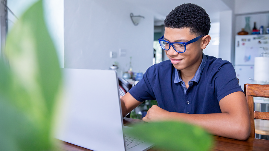 School age child wearing TechShield AR Coatings while using laptop